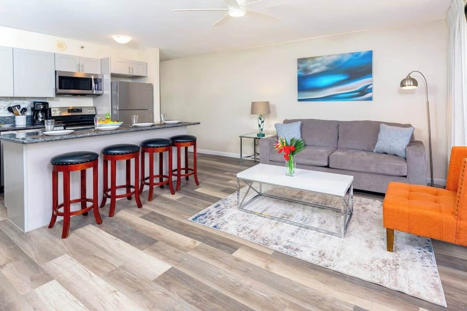 Open kitchen with a countertop-bar, bar stools and pull-out sleeper sofa and chair