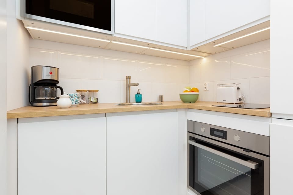Functional kitchen space featuring essential appliances and storage. Appliances such as the oven make it easy to cook home-cooked meals.