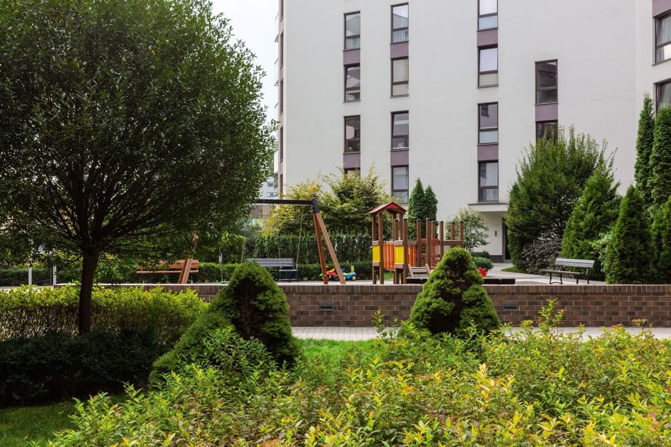 Residential buildings surrounded by greenery and pathways.