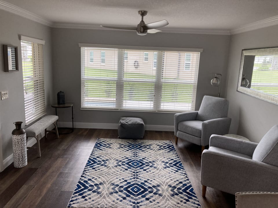 Bonus sitting area overlooks screened in lanai with pool
