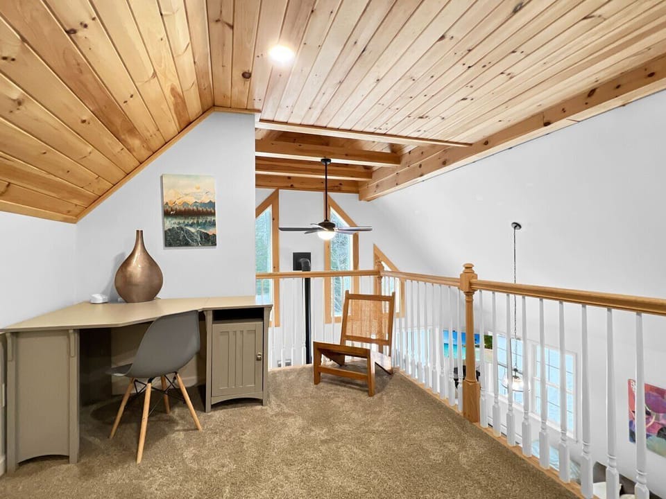 Upper level loft with desk and workspace.