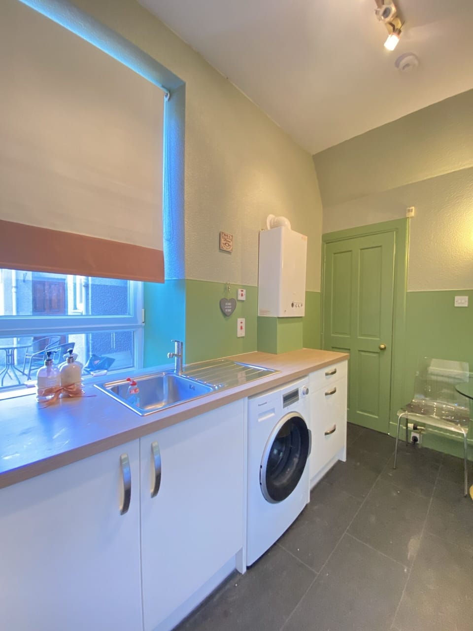 Kitchen with washing machine (laundry detergent not provided)