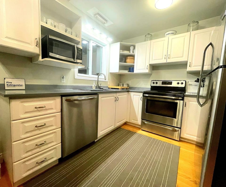 Well stocked kitchen with dishwasher, microwave, coffee maker, and more