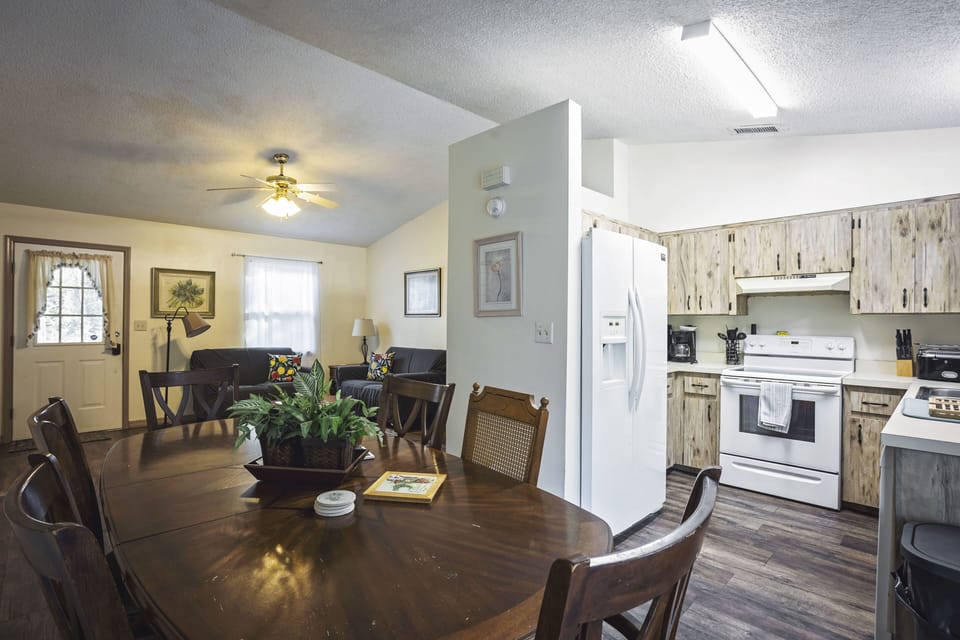 dining table view of kitchen and living room in background