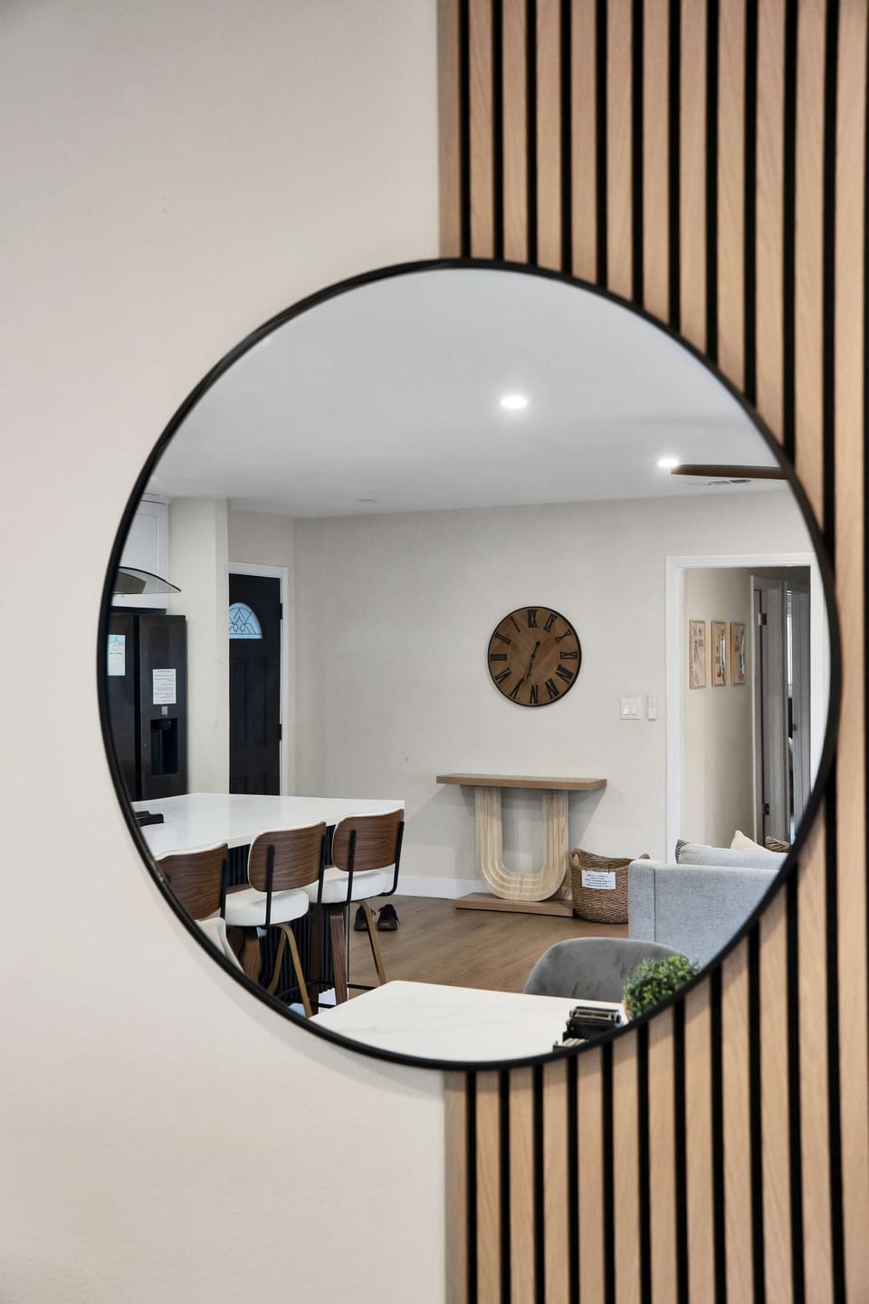 A stylish mirror in the dining room, reflecting light to create a bright and inviting atmosphere.