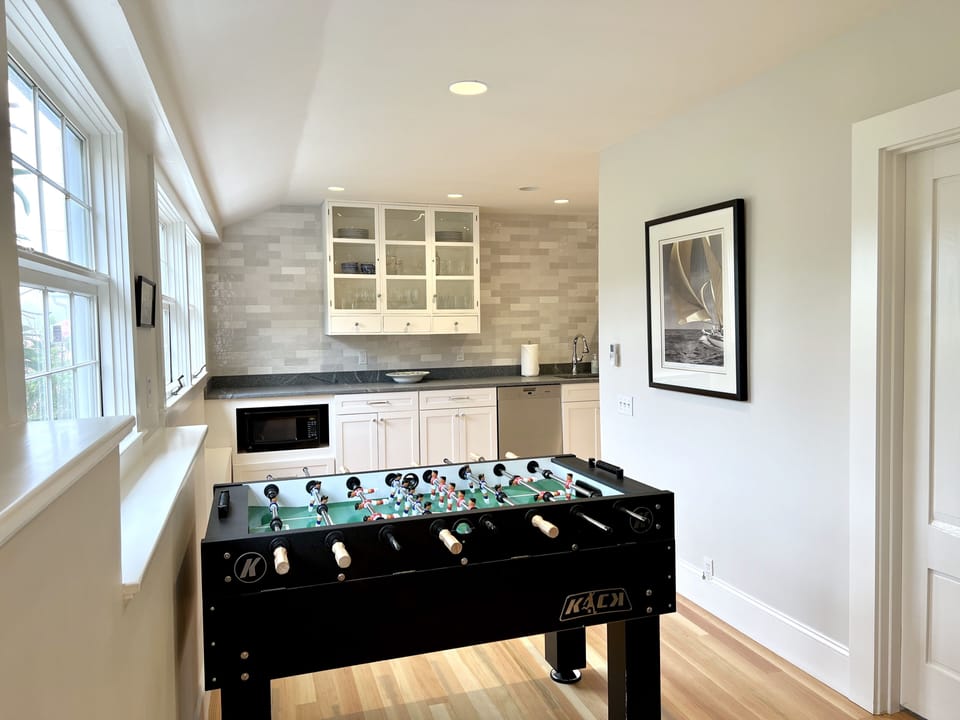 Game room with second mini bar/kitchen area (w/ door to laundry room on right)