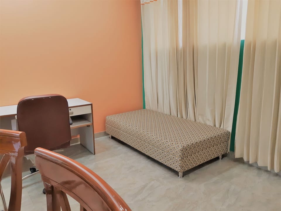 Lobby or living room with dining table, couch, Fridge, working desk, ironing tab