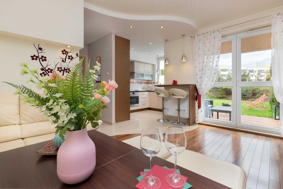 A bright kitchen view showcasing a dining table, white cabinets, and elegant kitchen decor.