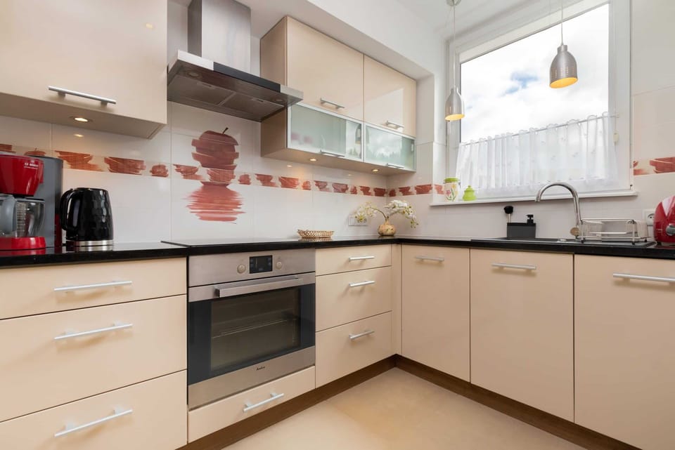 A bright kitchen view showcasingwhite cabinets, and elegant kitchen decor.