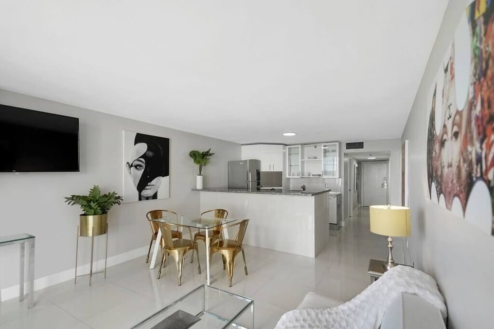Living area, balcony access, Roku streaming Tv, dining area, full kitchen