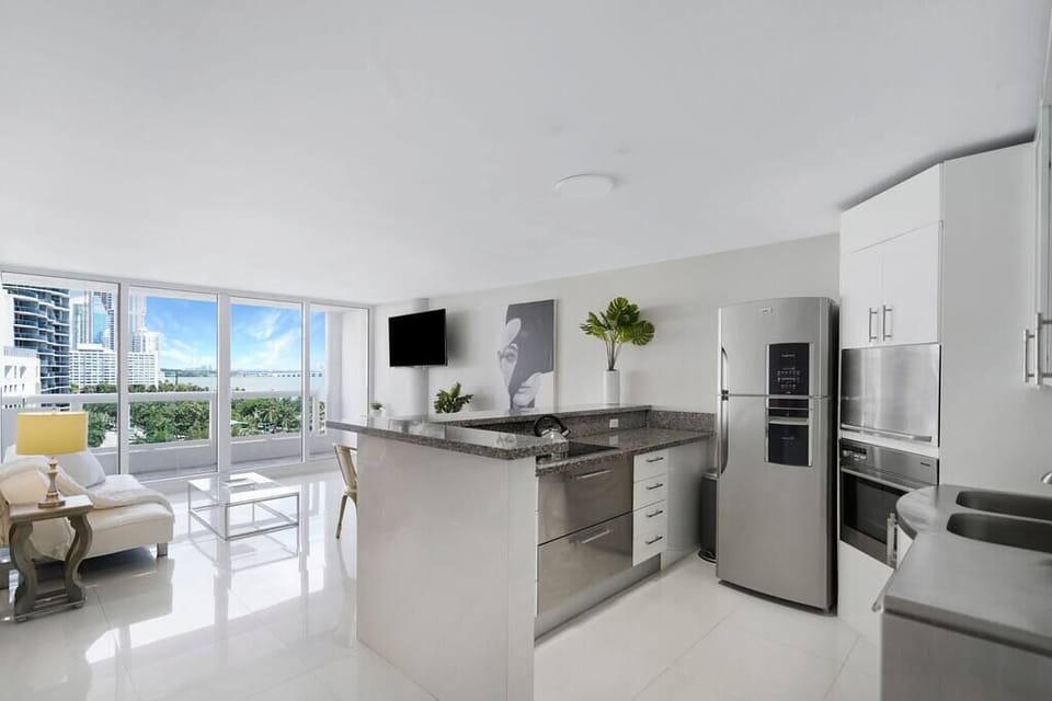Living area, balcony access, Roku streaming Tv, dining area, full kitchen