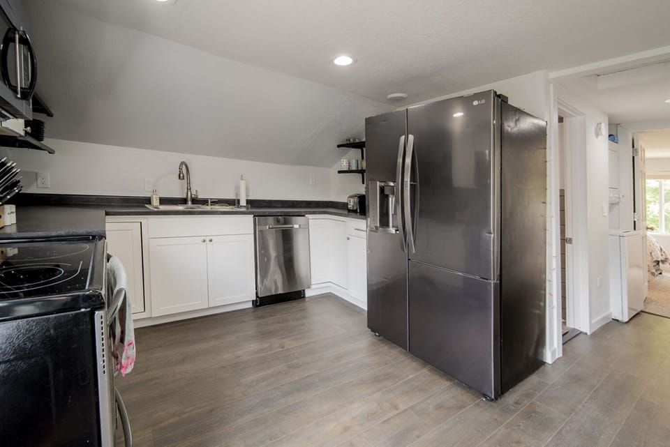 The kitchen is complete with stainless steel appliances.