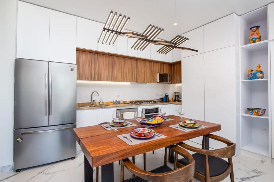 View of the dining table and kitchen.