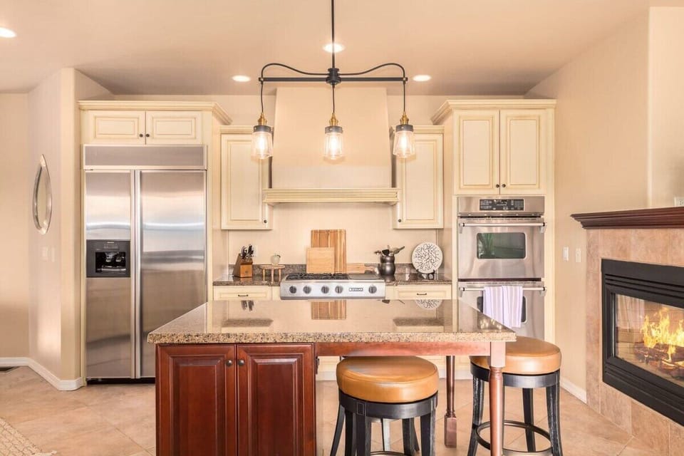 Fully Stocked Kitchen with High End Appliances and Cozy Gas Fireplace