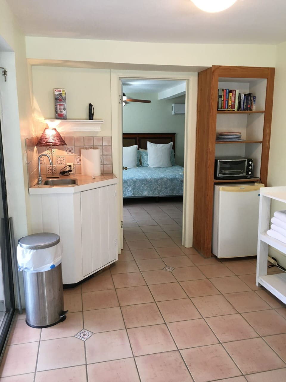 Kitchenette with sink, refrigerator, hot plate and toaster oven.