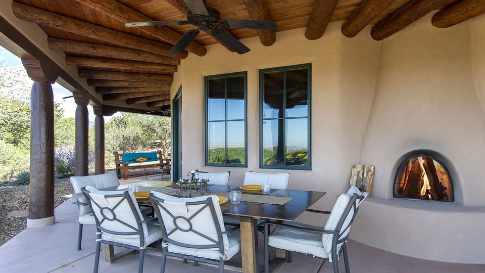 Portal with dining table and kiva fireplace