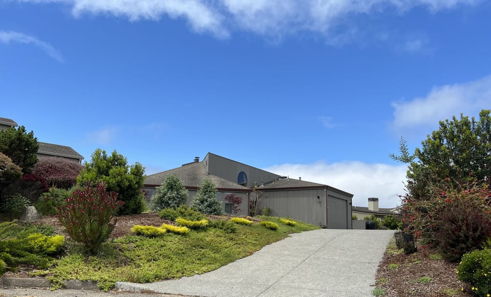 Driveway with landscaped entrance and sunny view from the street. 4 cars max.