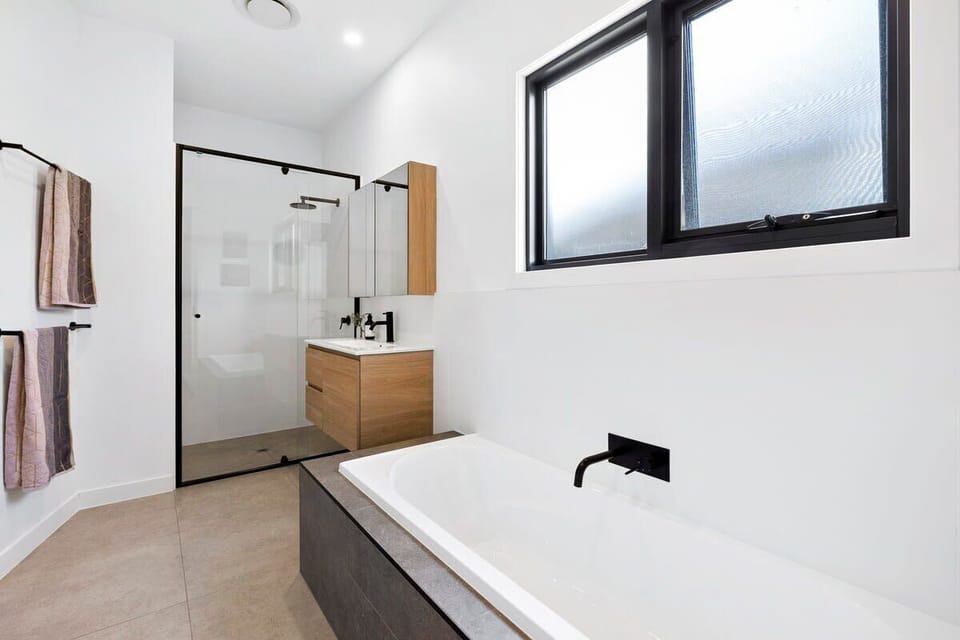 Master ensuite with a shower, vanity, bath and convenient powder room