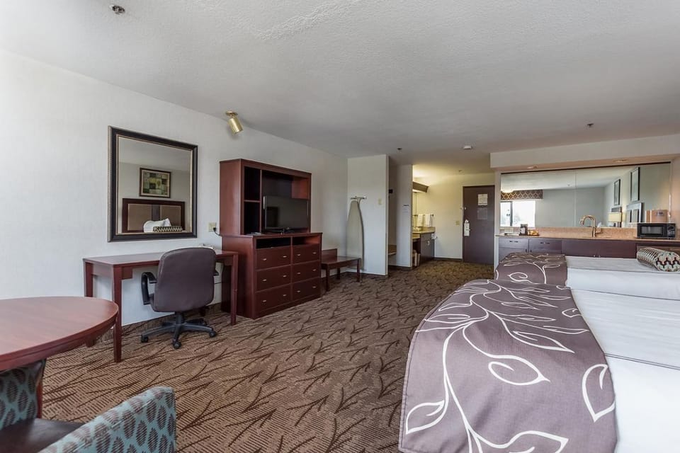 Lounge comfortably with two beds, seating, and natural daylight.