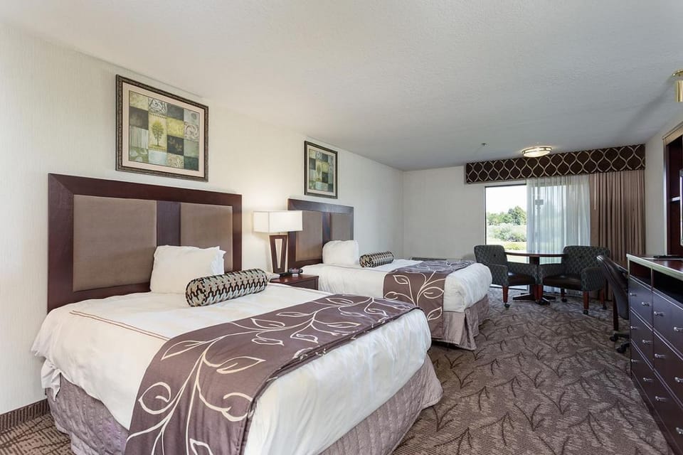 Relax together with two comfy beds and a bright window view.