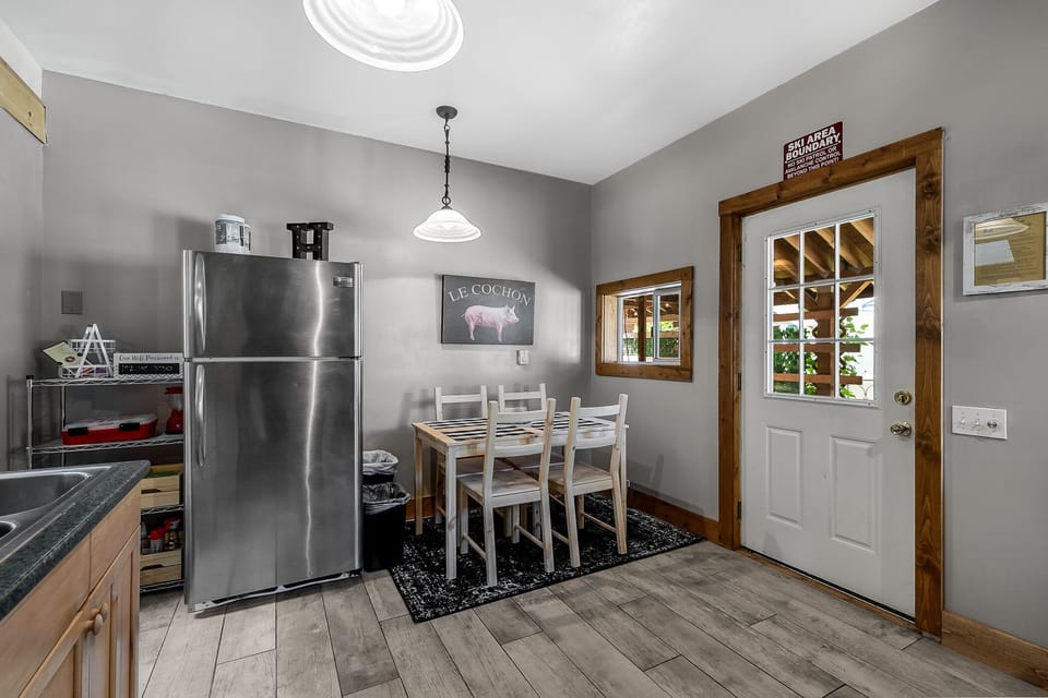 Door to the backyard visible beside seating for 4 in the kitchen