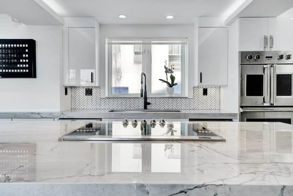 3rd FLOOR: KITCHEN. 30 foot island. Viking appliances (double oven, warmer, full fridge, wine fridge, dishwasher, drawer microwave, 6 burner cooktop with retractable vent, dishwasher), built-in Miele espresso machine. 48 inch sink. 