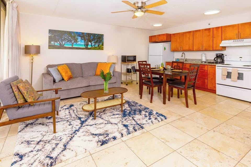 Open kitchen with a dining table and chairs for 4 people, pull-out sleeper sofa, chair, coffee table