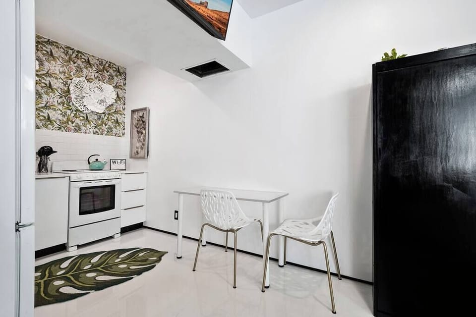 The kitchen is stocked with a full set of appliances including basic kitchen utensils. 
