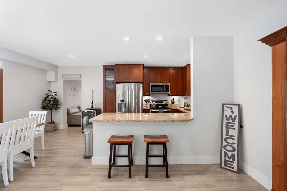 The kitchen is stocked with a full set of appliances, including a Keurig and basic kitchen utensils and seating at the bar for 2. 
