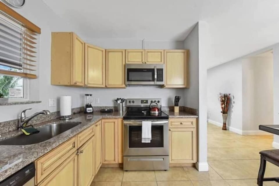 Kitchen comes with microwave, oven, dishwasher and basic utensils. .