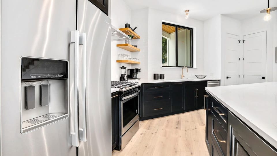 The kitchen has ample storage and stainless steel appliances