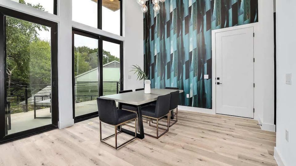 The dining table is adjacent to the kitchen