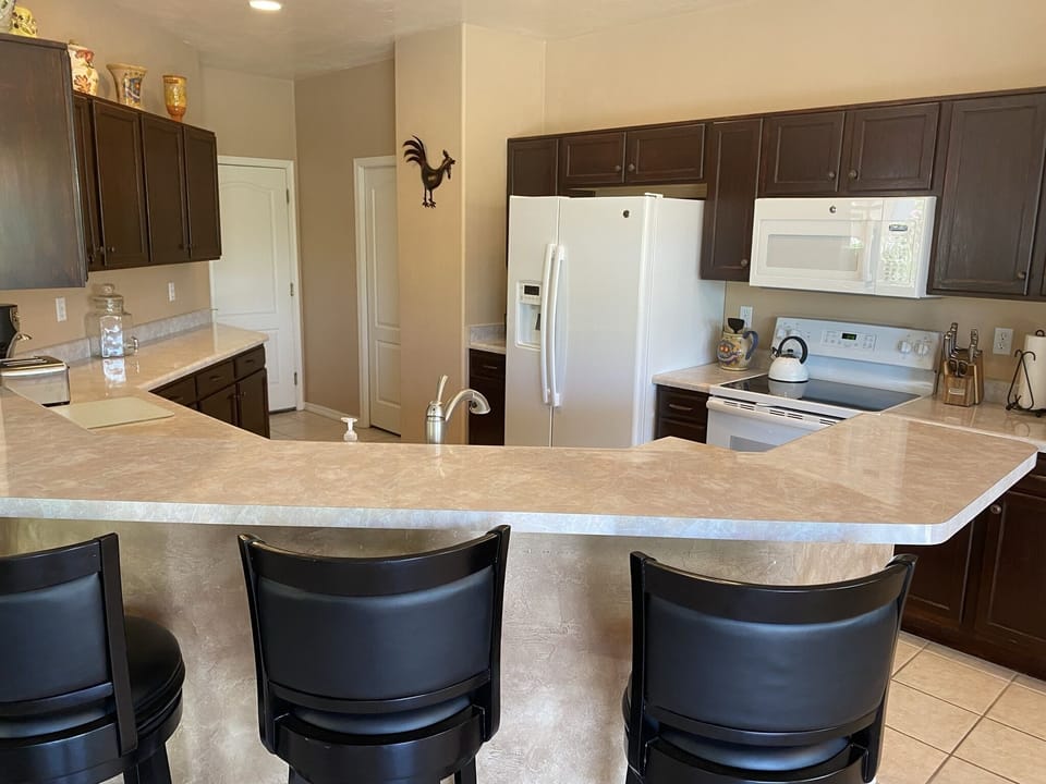 Kitchen with bar and five bar stools