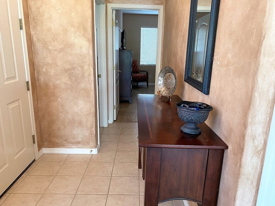 Entry way with guest bedroom and bathroom down the hall to the left