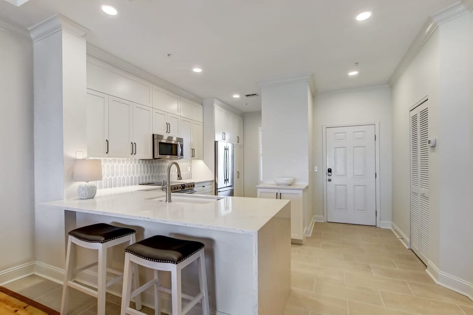 Brand New Kitchen With Quartz Countertops, Stylish Tiled Backsplash, Stainless Steel Appliances and Counter Seating for 2