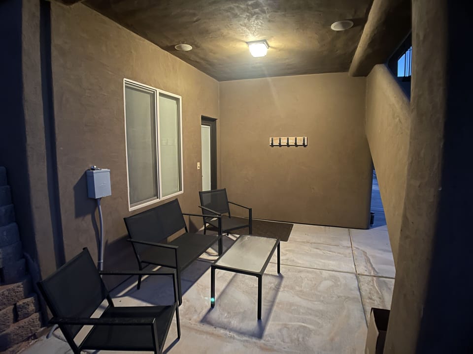 Patio seating outside entry door.