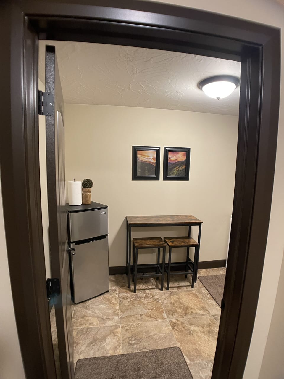 Kitchen/Laundry with freezer, refrigerator, bar, microwave, Keurig, and laundry