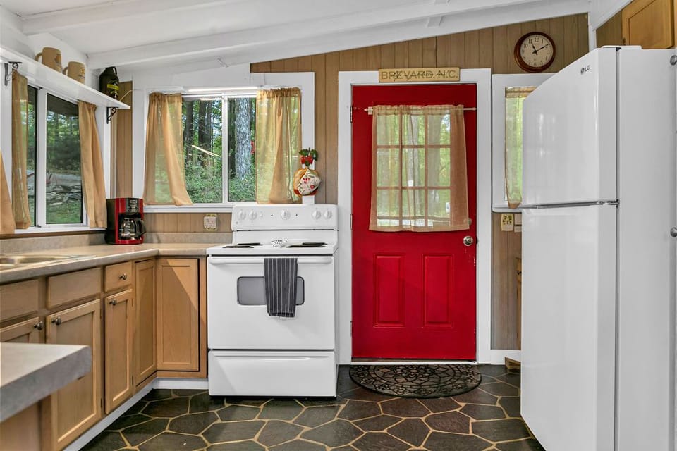 Electric four burner stove, full size fridge Note: no ice maker.  Trays provided