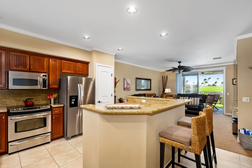 Full kitchen with granite countertops, breakfast bar, and stainless steel appliances