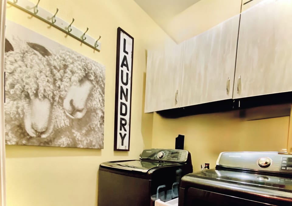 Laundry room with 5.4 CF Samsung Washer and Dryer with steam program.