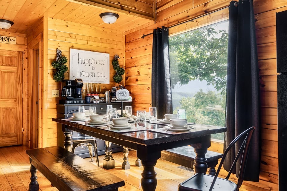 Custom dining table seats 8-10 and the cabin features a full coffee bar for all guests!