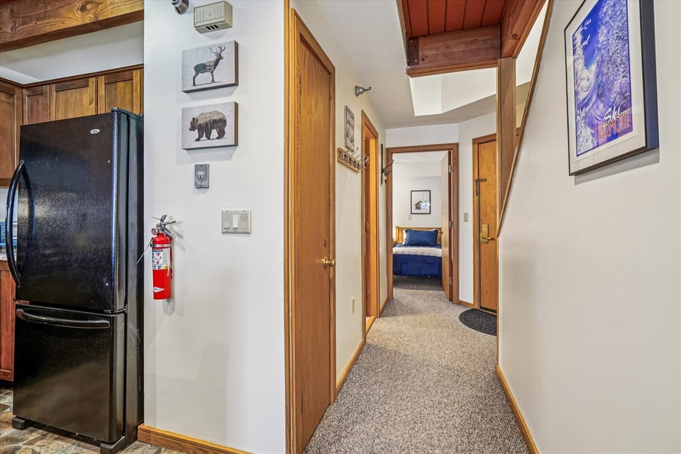 A functional entry area with hooks, stairs to the upper level, and a direct line into the living space — perfect for managing coats, gear, and boots.
