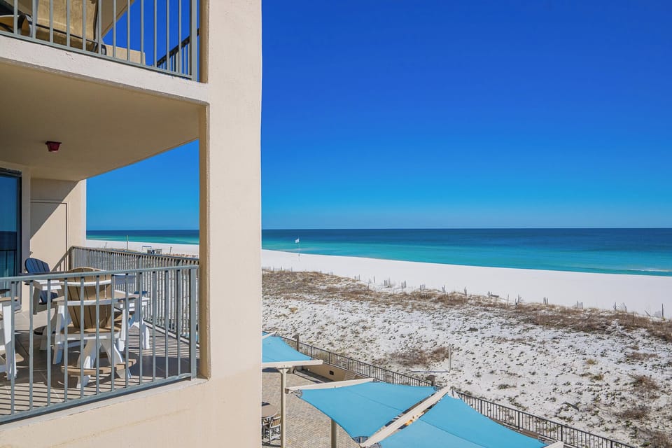 Your balcony offers a clear view of the calm coast with rhythmic waves and soft white beach grasses