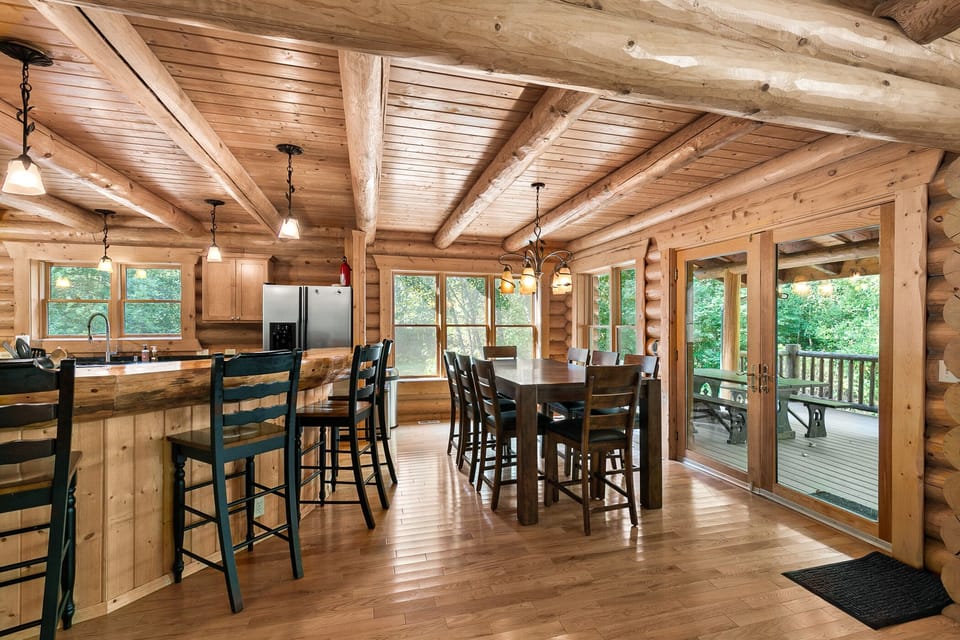 A dining area beside the kitchen holds seating for 8 and an exit to the back deck
