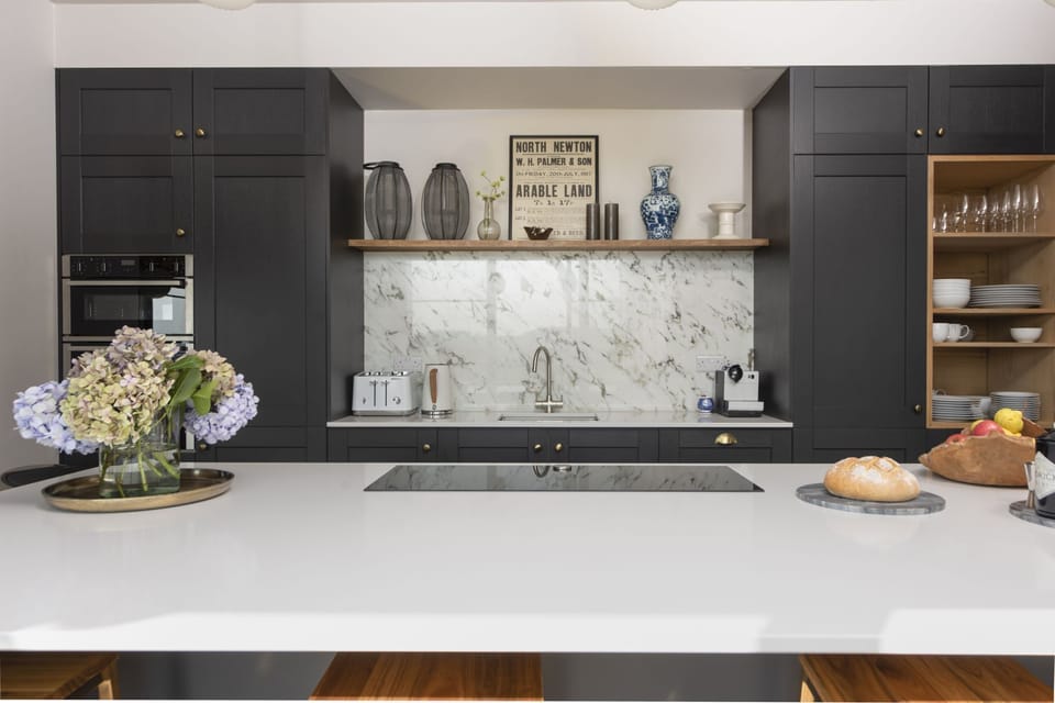 The kitchen with a hob, stovetop and view to the garden - Decoy Farm
