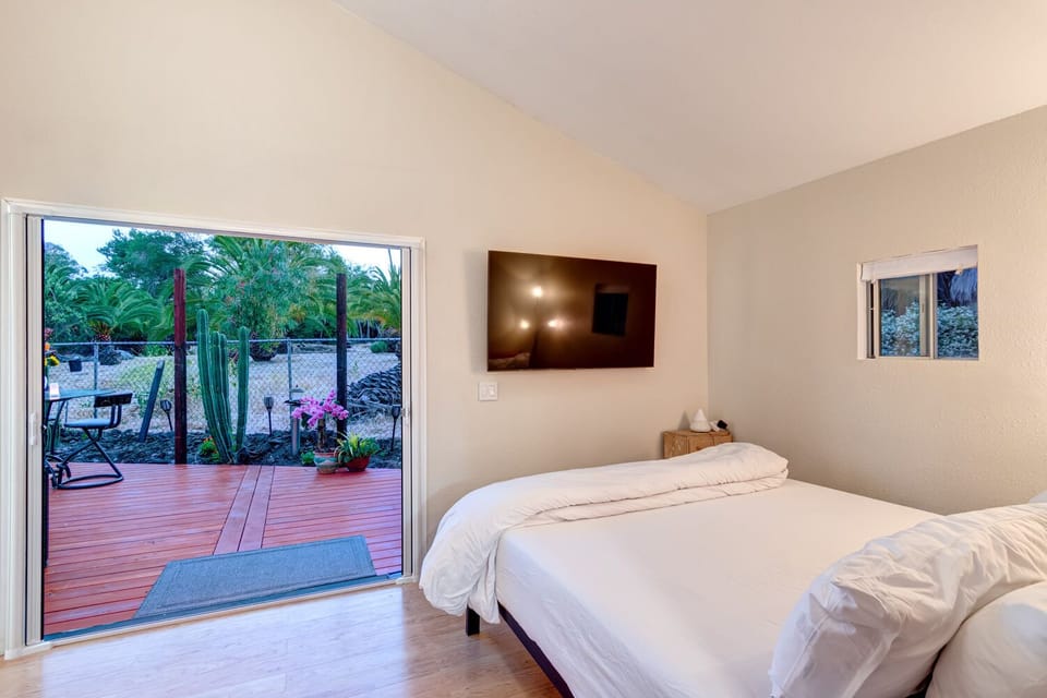 King bed with luxury linens, Large 75" TV, private bath, and private deck.