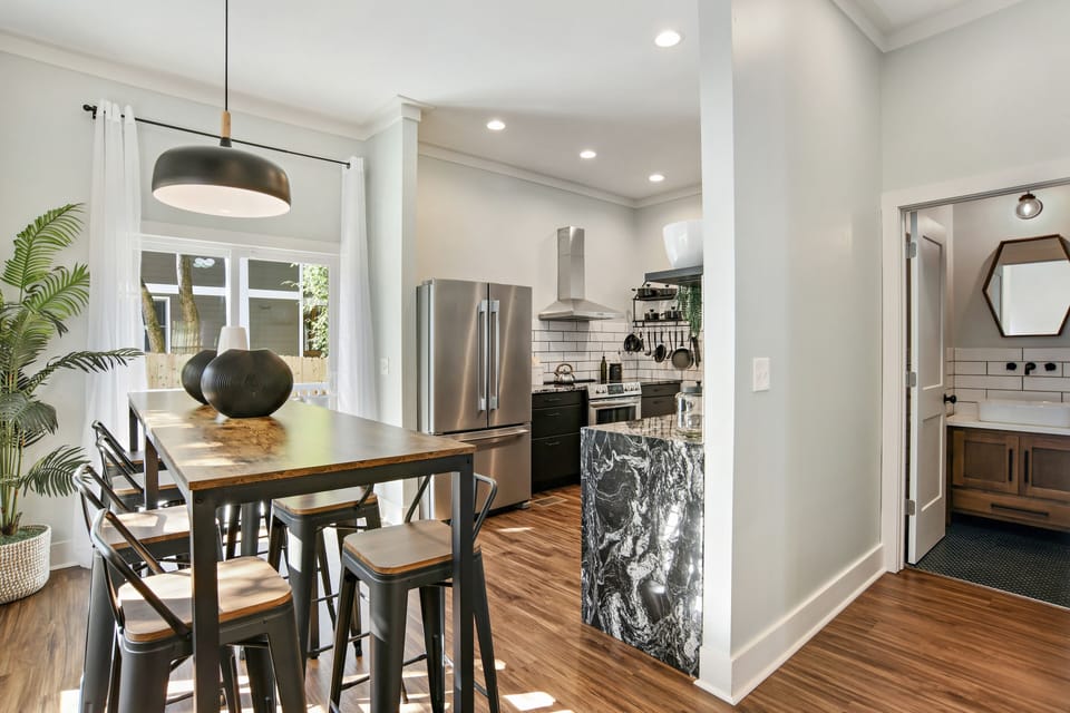 hallway to the right leads to half bath. Beyond the table leads to back patio