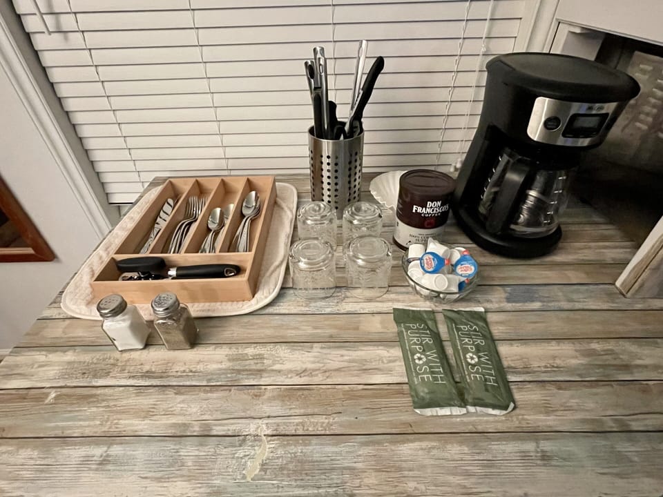 Silverware, kitchen utensils, coffee pot and a few coffee supplies 