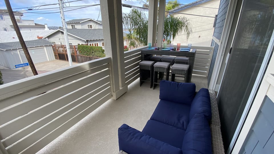 2nd floor deck with Mission Bay water view, dining for 6 and love seat.