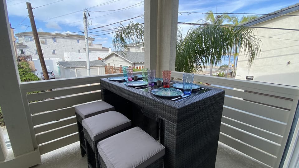 2nd floor deck with Mission Bay water view, dining for 6 and love seat.